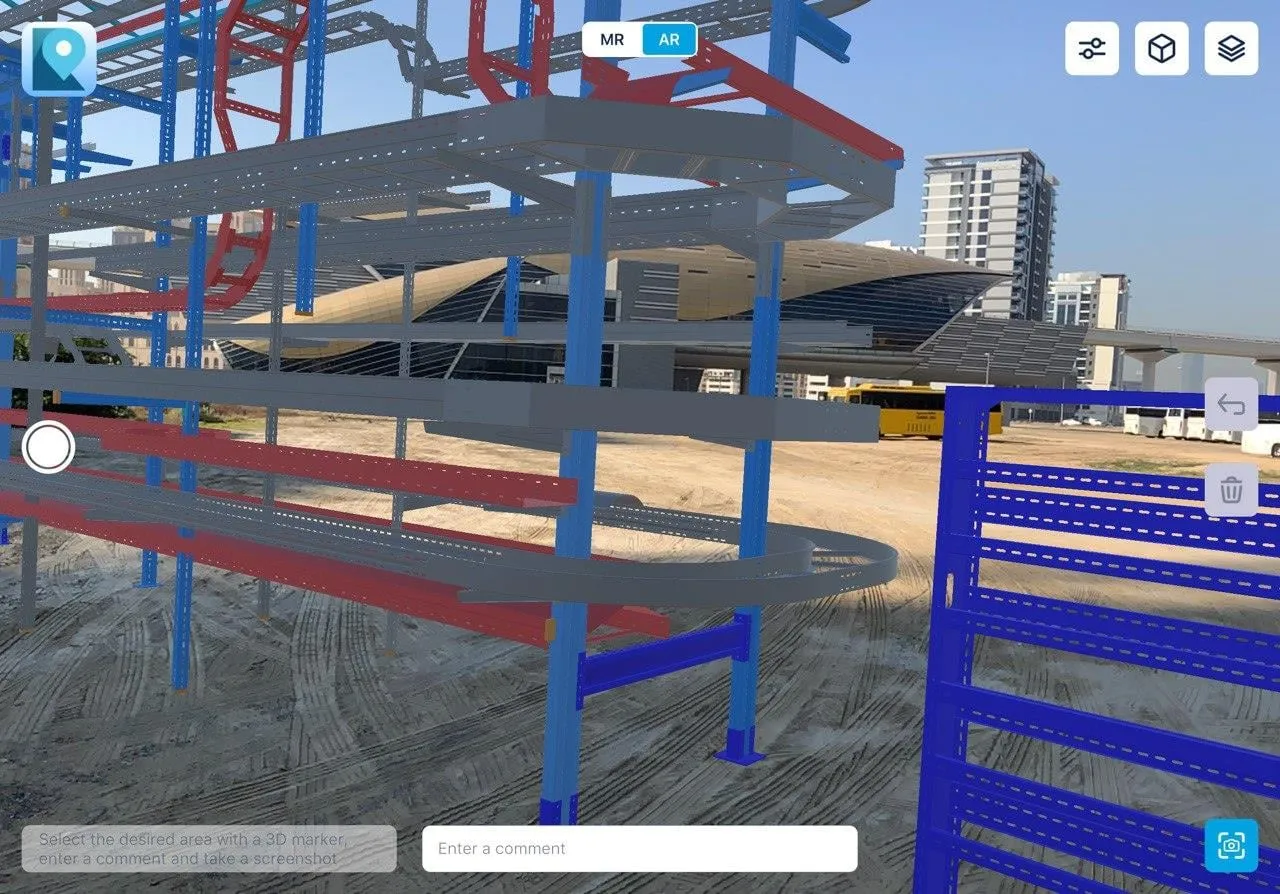 XR Blueprint 3D on a tablet: a BIM model of steel frames and cable trays overlaid on a real building site.
